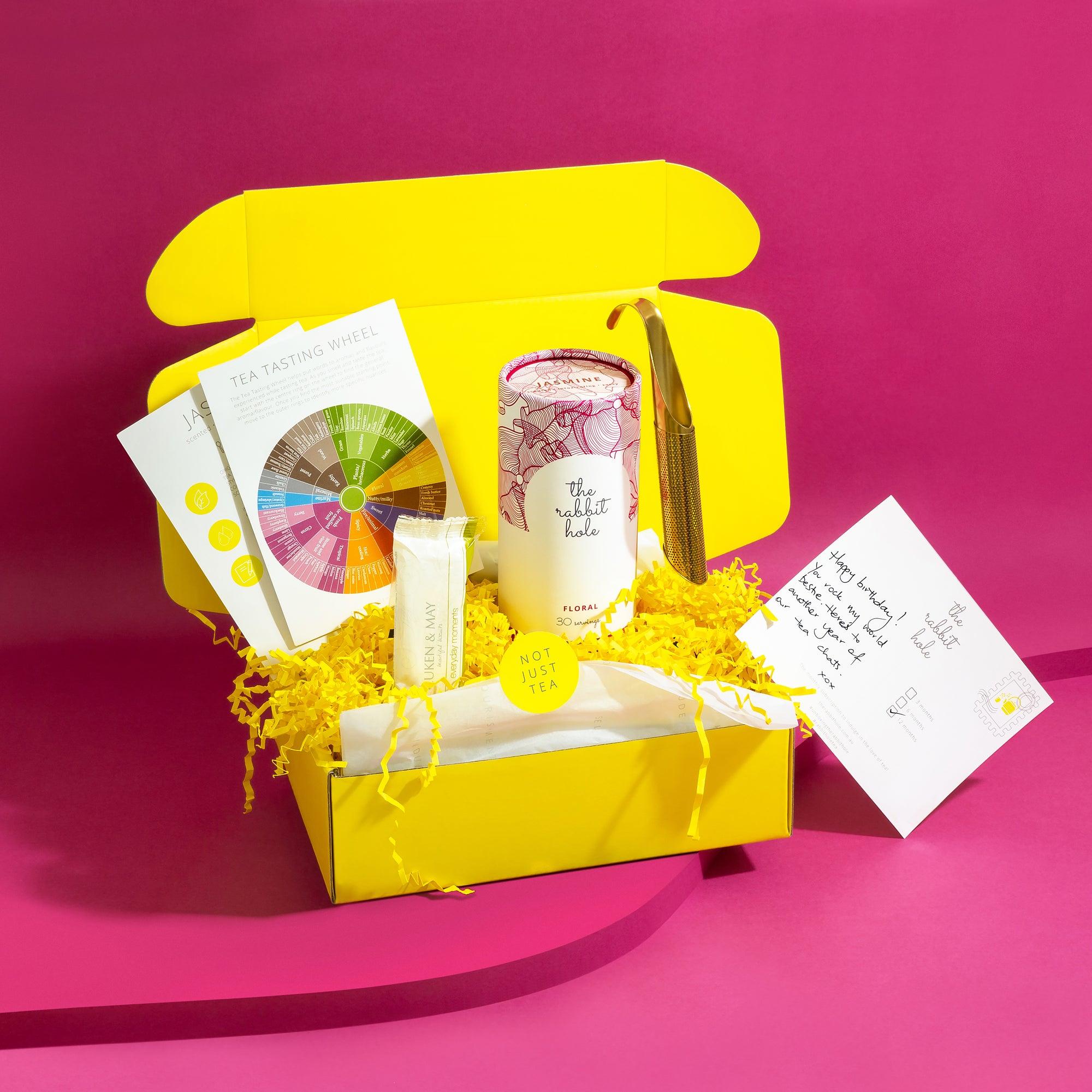 Tea mail by The Rabbit Hole - monthly tea subscription in yellow gift box on bright pink background.