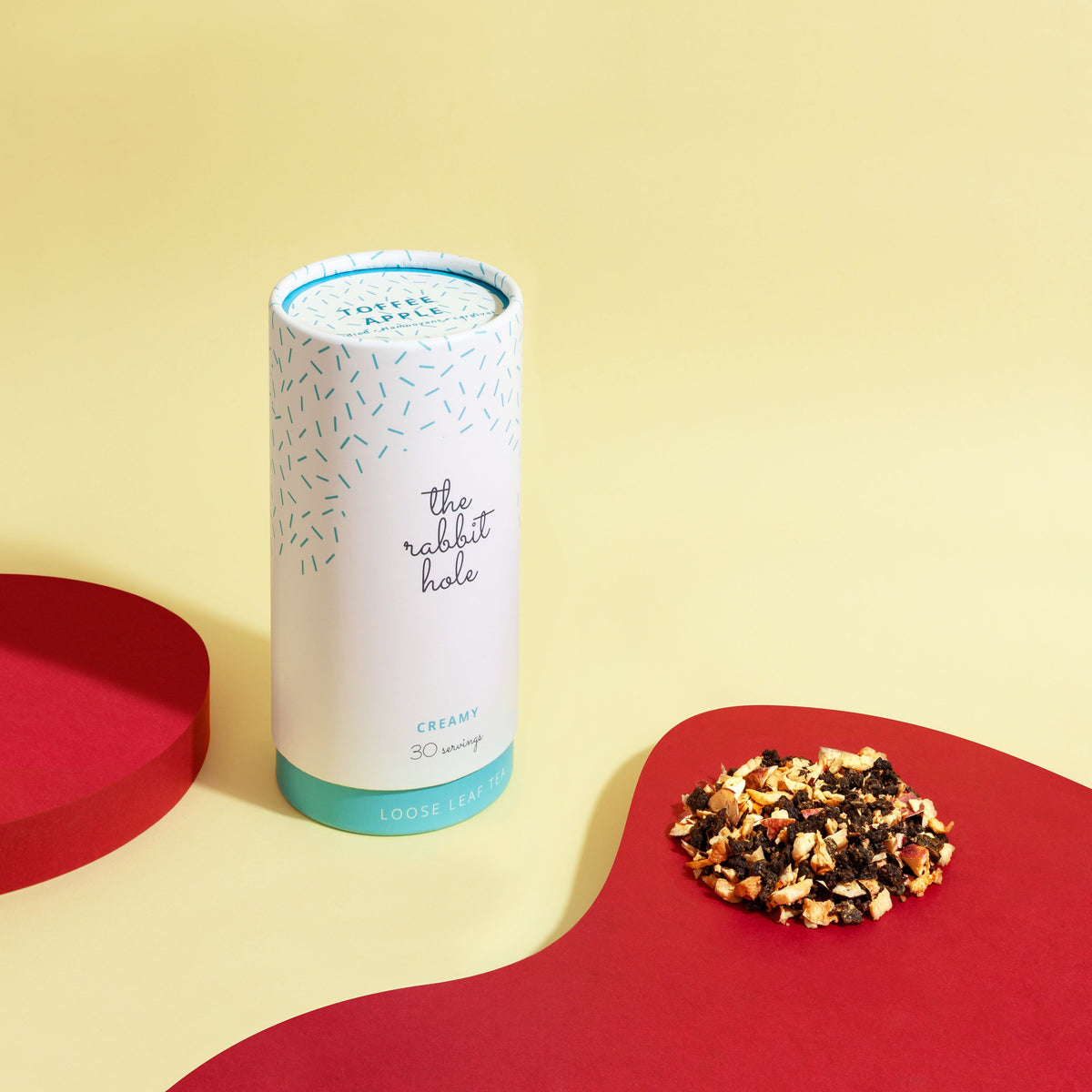 Toffee Apple loose leaf Creamy tea by The Rabbit Hole - Australian Made Tea - canister on a colourful yellow and red background