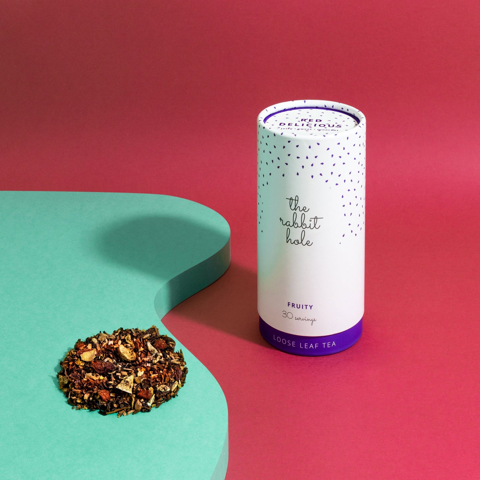 Red Delicious Fruity loose leaf tea by The Rabbit Hole - Australian Made Tea - canister on bright red and green background