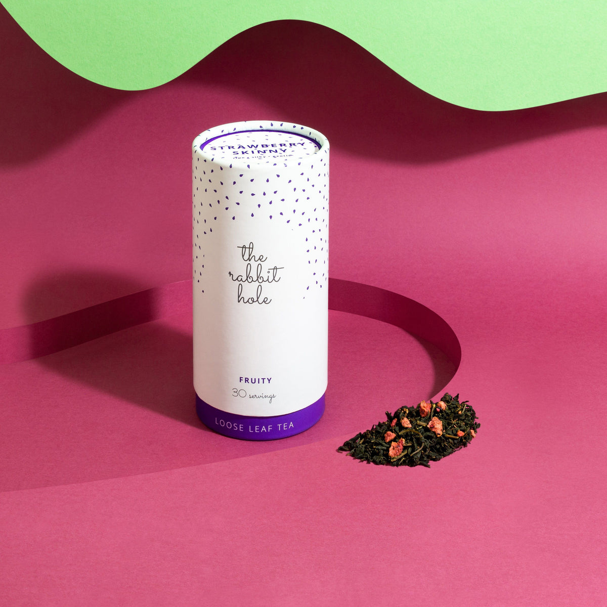 Strawberry Skinny Loose leaf Fruity tea by The Rabbit Hole - Australian Made Tea - canister on a bright pink and green background