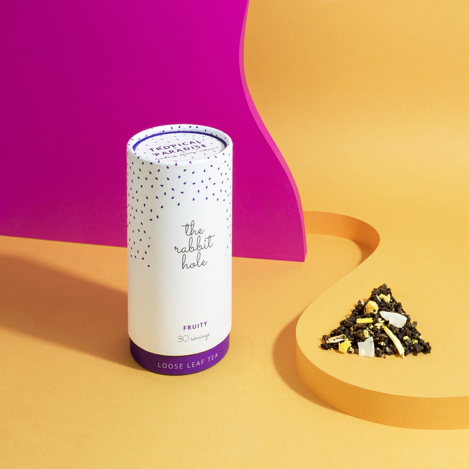 Tropical Paradise Fruity loose leaf tea by The Rabbit Hole - Australian Made Tea - canister on a pink and yellow background