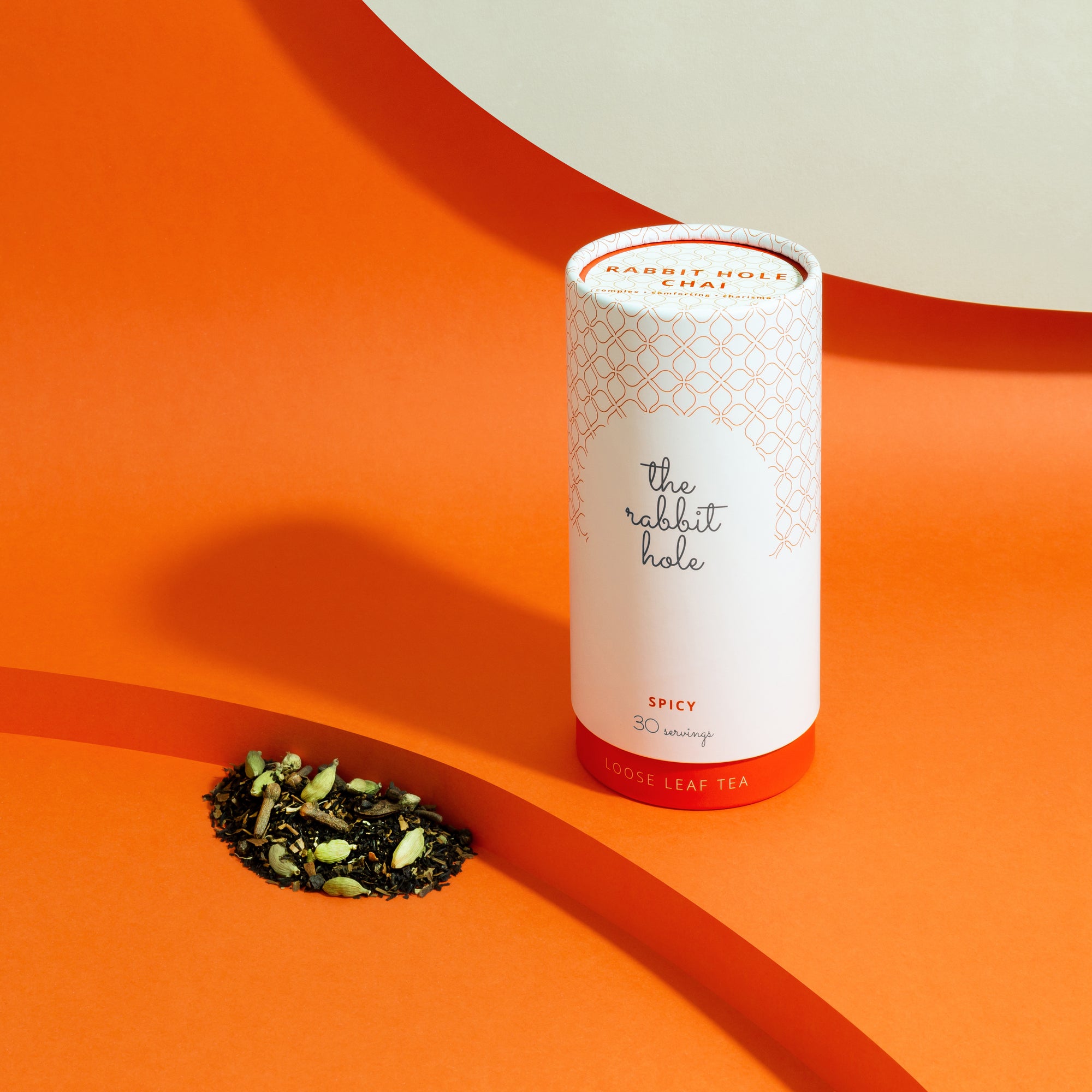 Rabbit Hole Chai loose leaf tea by The Rabbit Hole - Australian Made Tea. Tea canister on colourful orange background